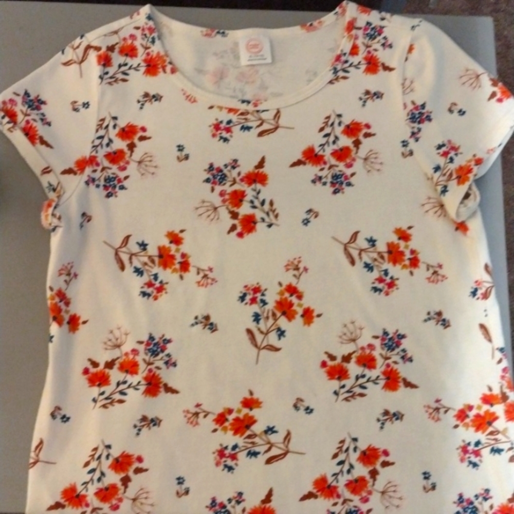 It is like a fall type shirt. It is white with color flowers.